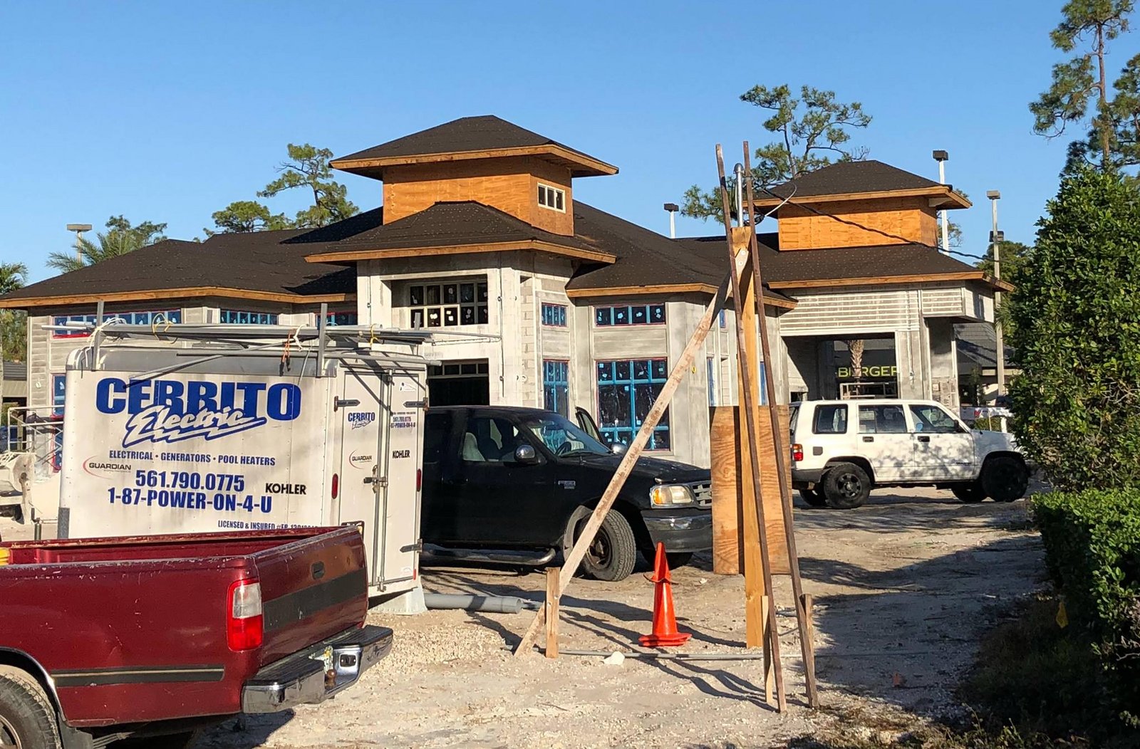 Cerrito Electric trailer with the blue logo parked at a commercial building under construction